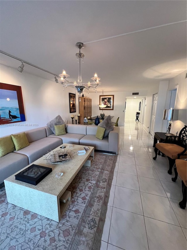 living room featuring light tile patterned flooring and a chandelier