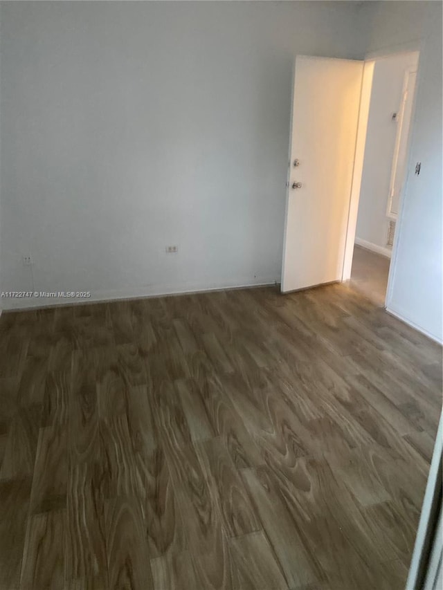 empty room featuring dark wood-type flooring