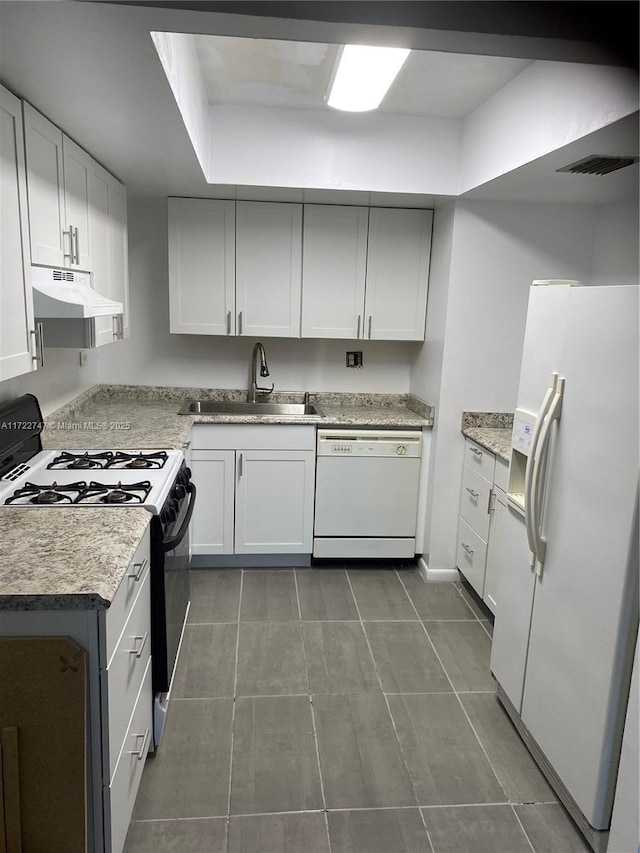 kitchen featuring white appliances, white cabinetry, and sink