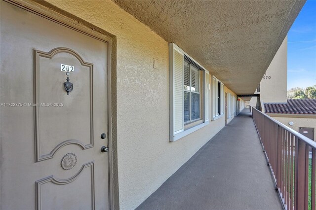 4570 NW 18th Ave Unit 202, Deerfield Beach, FL 33064 - property entrance featuring stucco siding and a balcony