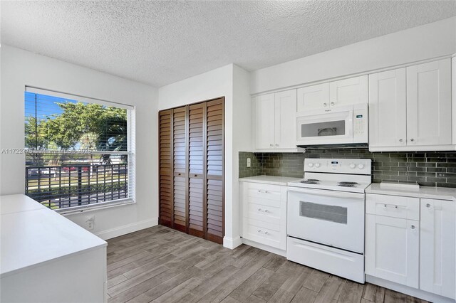4570 NW 18th Ave Unit 202, Deerfield Beach, FL 33064 - hallway with baseboards, wood finished floors, and a textured ceiling
