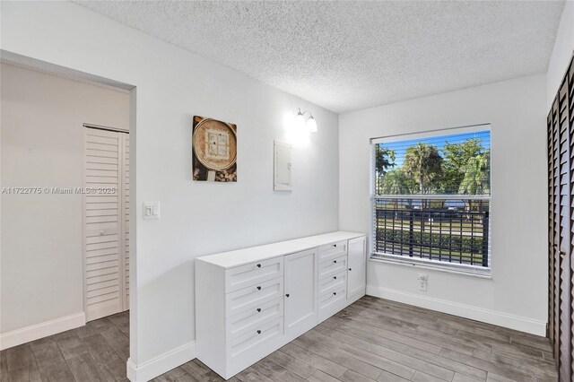 4570 NW 18th Ave Unit 202, Deerfield Beach, FL 33064 - kitchen with white appliances, light wood-type flooring, light countertops, a sink, and a textured ceiling