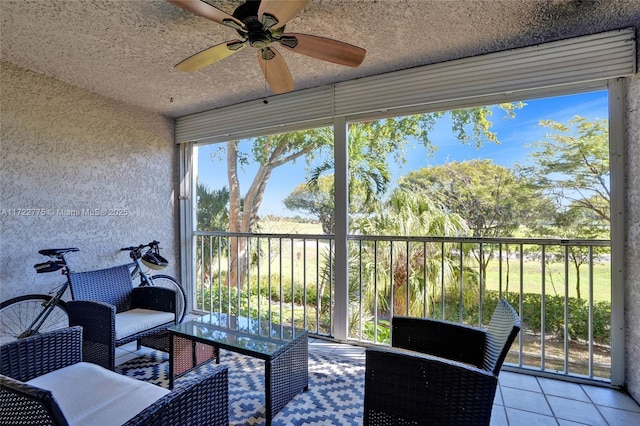 sunroom featuring ceiling fan and a wealth of natural light