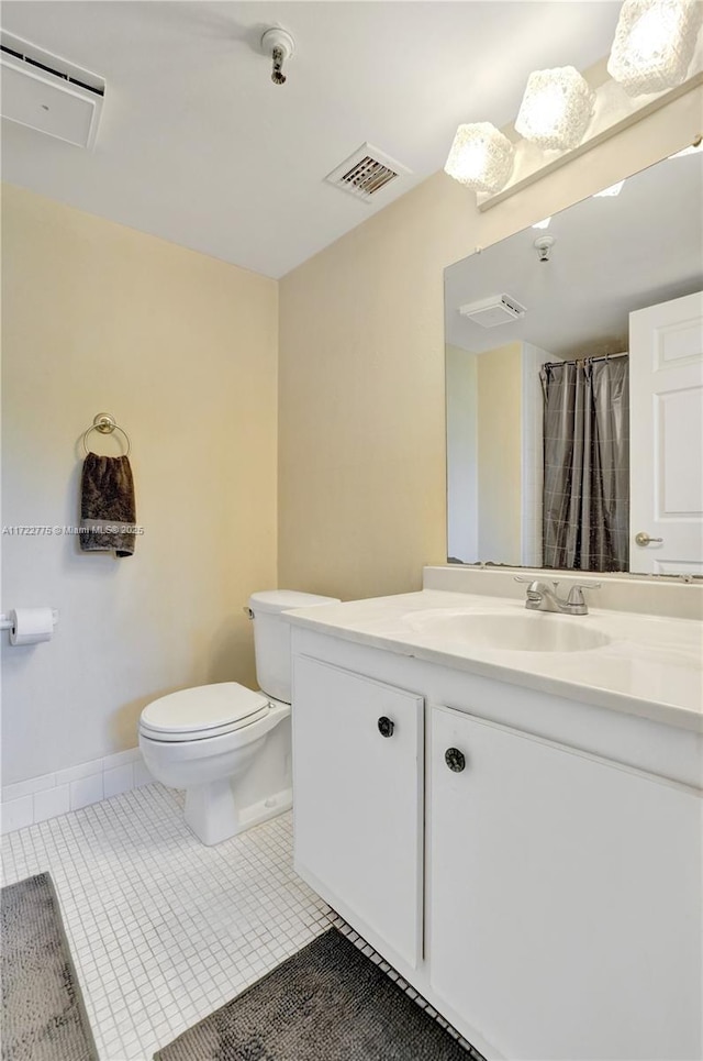 bathroom with tile patterned floors, vanity, and toilet