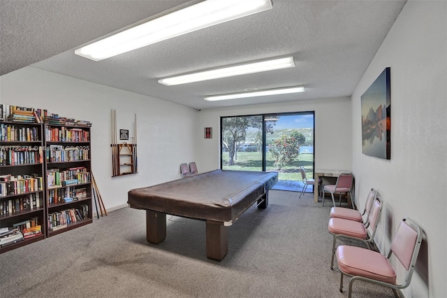 rec room featuring a textured ceiling, billiards, and carpet flooring