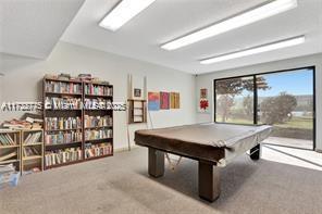4570 NW 18th Ave Unit 202, Deerfield Beach, FL 33064 - view of apartment building / complex featuring uncovered parking