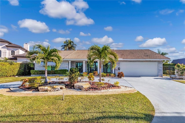 view of front of home featuring a front yard and a garage