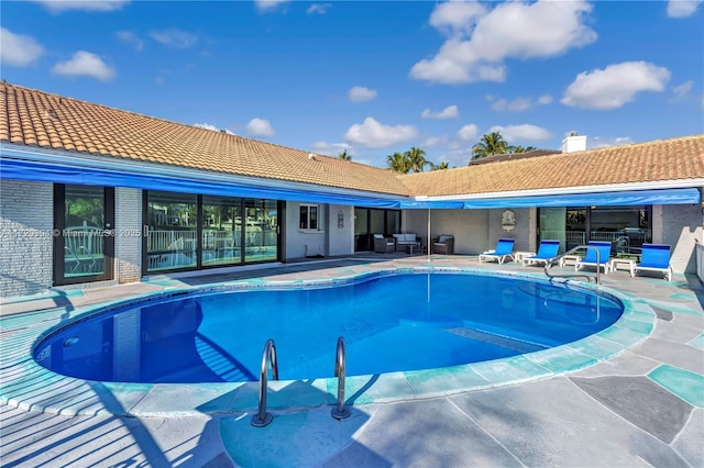 view of swimming pool featuring a patio area