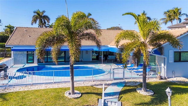 view of swimming pool featuring a patio and a yard