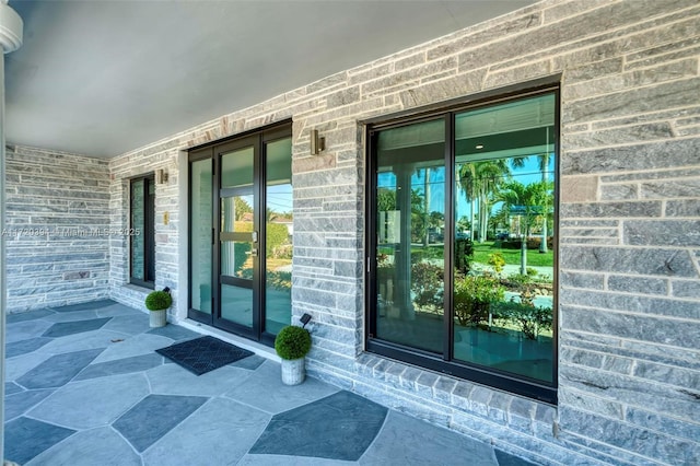 view of exterior entry featuring an AC wall unit