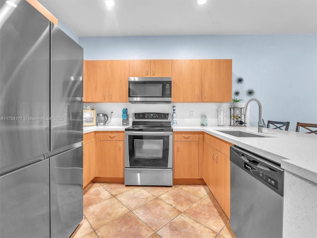 kitchen with sink, light tile patterned floors, backsplash, and appliances with stainless steel finishes