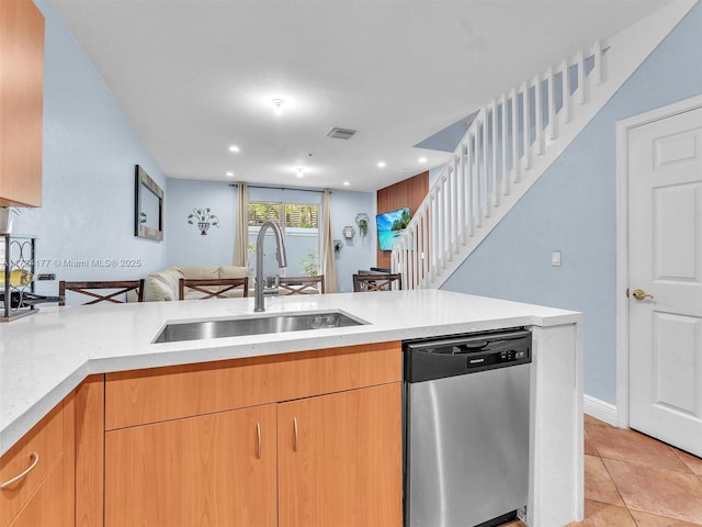 kitchen with sink, stainless steel dishwasher, kitchen peninsula, and light tile patterned floors