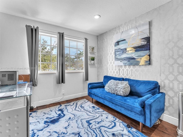 living area featuring hardwood / wood-style flooring and a textured ceiling