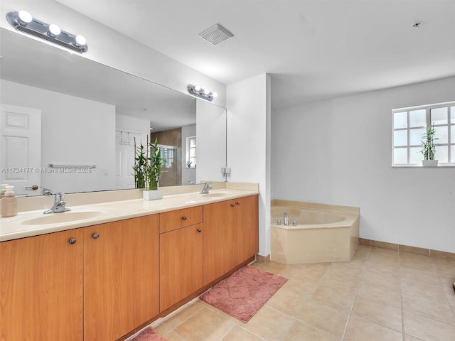 bathroom featuring shower with separate bathtub, vanity, and tile patterned floors