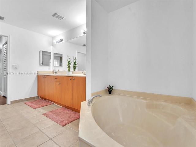 bathroom featuring a bath, tile patterned flooring, and vanity