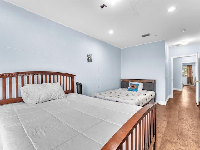 bedroom with hardwood / wood-style flooring