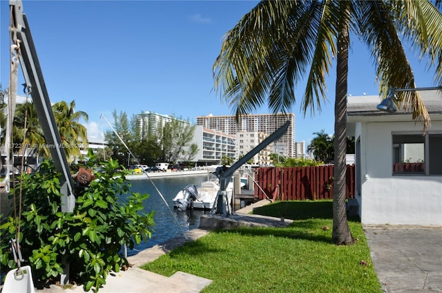 view of yard with a dock and a water view