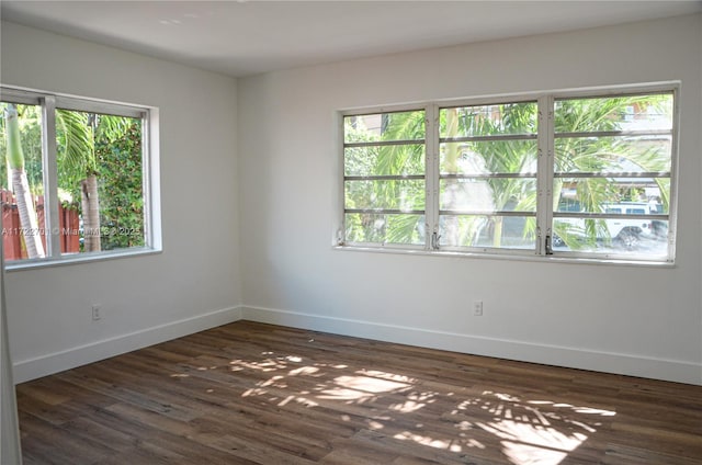 spare room featuring dark wood-type flooring