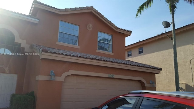 view of side of property with a garage