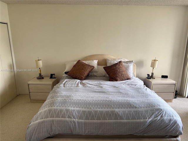 carpeted bedroom with a textured ceiling