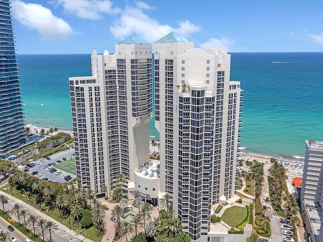 view of property with a beach view and a water view