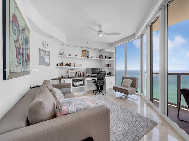 office space with floor to ceiling windows and ceiling fan