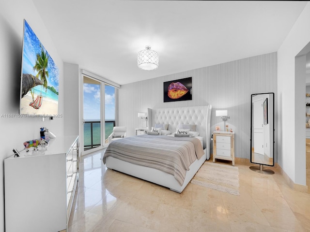 bedroom featuring a wall of windows and access to outside