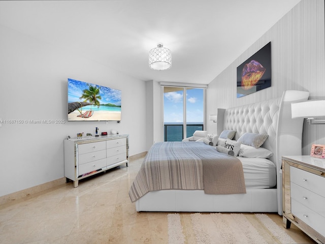 bedroom featuring access to exterior and a wall of windows