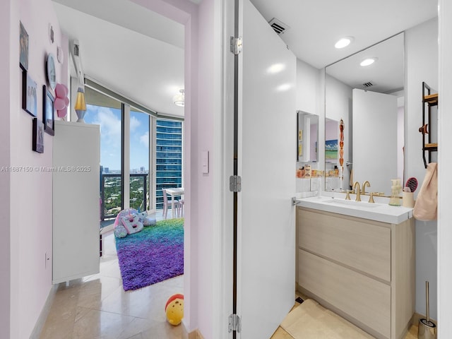 bathroom with vanity and floor to ceiling windows