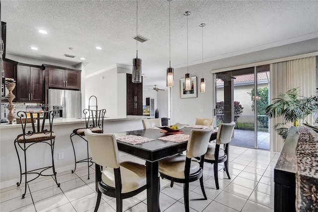 dining space with a textured ceiling, light tile patterned floors, ceiling fan, ornamental molding, and sink