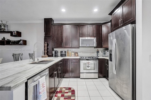 kitchen featuring ornamental molding, appliances with stainless steel finishes, light tile patterned flooring, dark brown cabinets, and sink