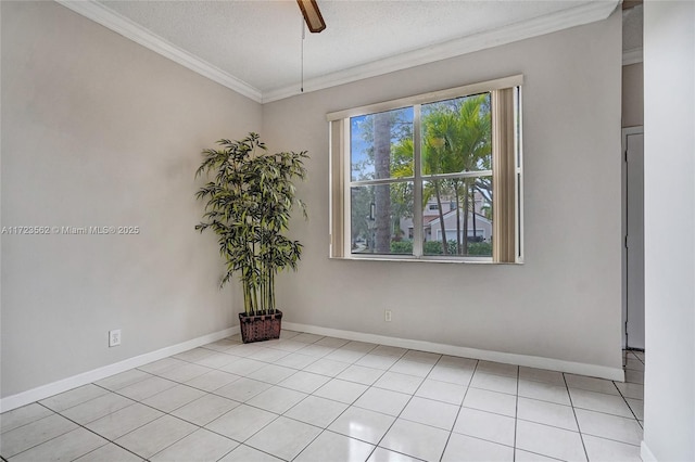 tiled spare room featuring ornamental molding and a textured ceiling