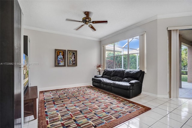 tiled living room featuring ceiling fan, ornamental molding, and a textured ceiling