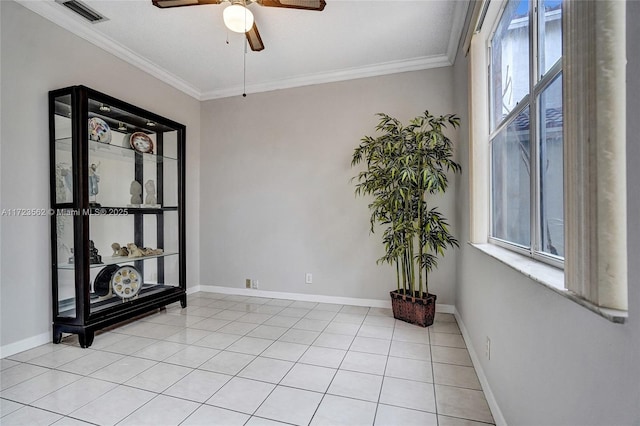 tiled empty room featuring crown molding and ceiling fan