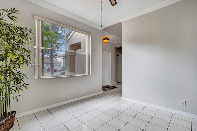 tiled spare room featuring crown molding, a textured ceiling, and ceiling fan