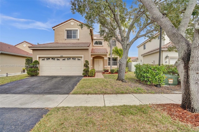 mediterranean / spanish-style home with a garage and a front lawn