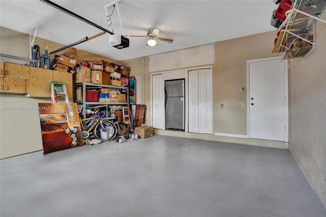 garage with ceiling fan, a garage door opener, and stainless steel fridge