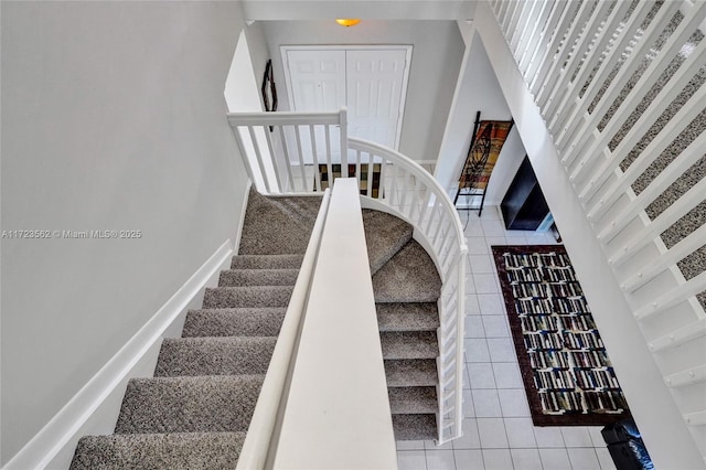 staircase featuring tile patterned flooring