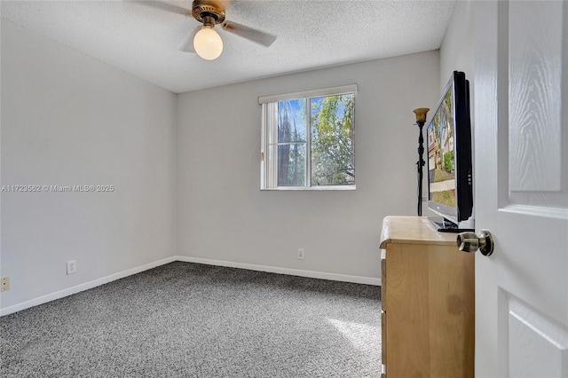 spare room with ceiling fan, carpet floors, and a textured ceiling