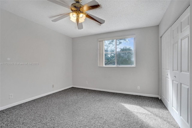 unfurnished bedroom featuring ceiling fan, carpet, a textured ceiling, and a closet