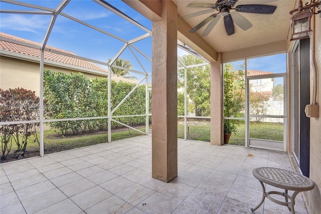 unfurnished sunroom featuring ceiling fan