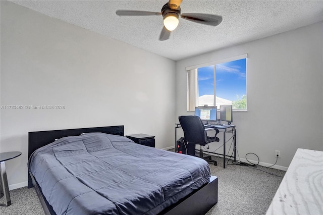 bedroom with ceiling fan, light colored carpet, and a textured ceiling