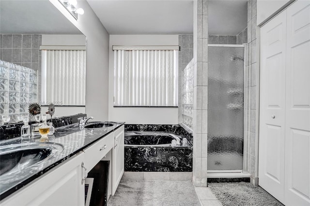 bathroom featuring vanity, tile patterned floors, and separate shower and tub