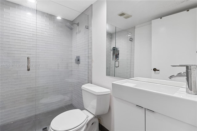 bathroom with toilet, an enclosed shower, and vanity