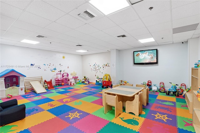 recreation room featuring a drop ceiling