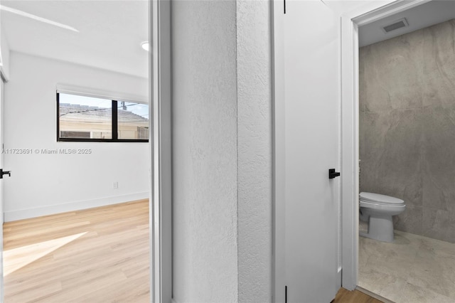 bathroom with wood-type flooring and toilet