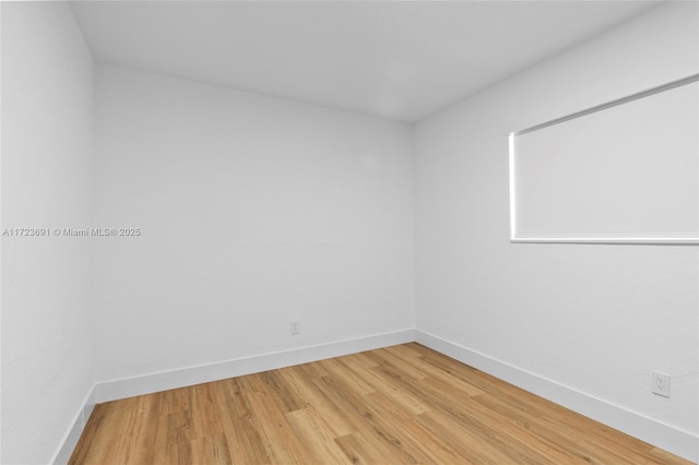 spare room featuring wood-type flooring