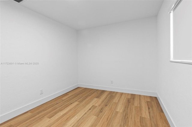 spare room featuring light hardwood / wood-style flooring