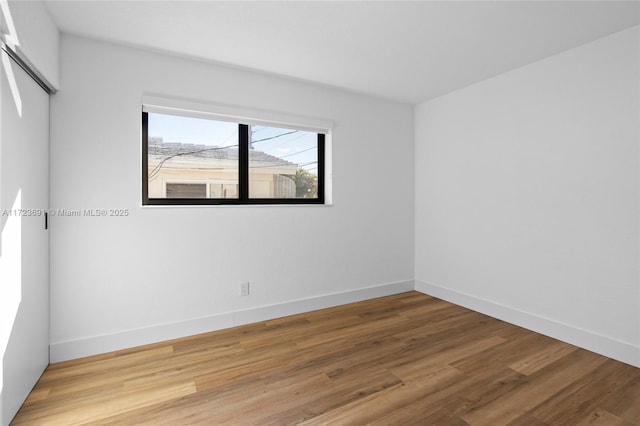 empty room featuring wood-type flooring