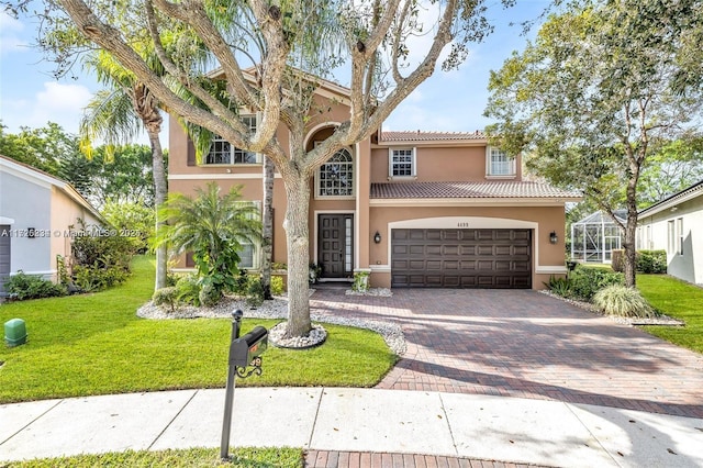 mediterranean / spanish house with a lanai, a front yard, and a garage